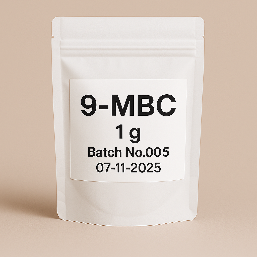 image of a white, resealable stand-up pouch labeled 9-MBC 1g, Batch No.005, dated 07-11-2025. The pouch is placed against a neutral beige background, ideal for supplement product listings or e-commerce use