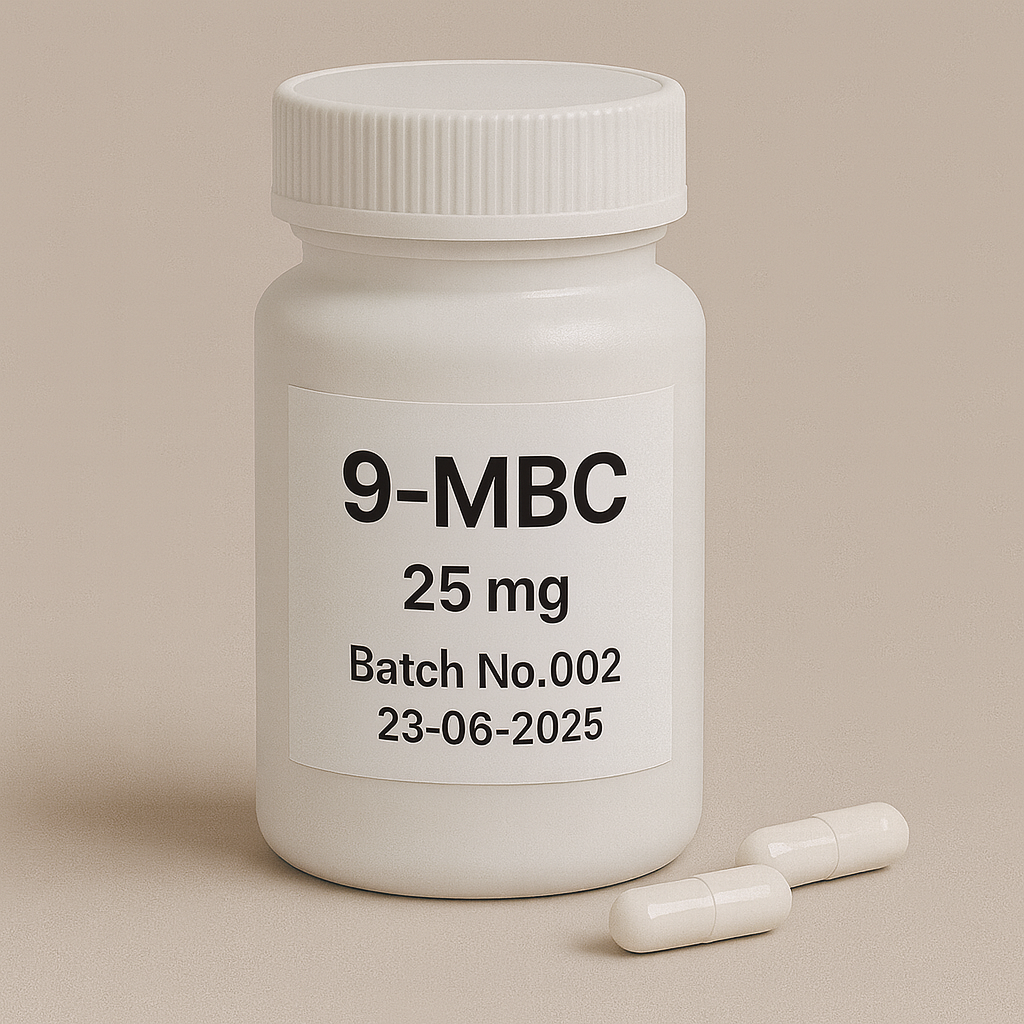 White plastic pill bottle labeled "9-MBC, 25 mg, Batch No.002, 23-06-2025" on a beige background, with two white capsules lying beside it.