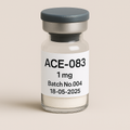 Glass vial labeled 'ACE-083 1 mg, Batch No.004, 18-05-2025' containing a white lyophilized powder, sealed with a gray rubber stopper and silver cap, photographed against a soft beige background