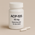 a white pill bottle labeled ACP-105 10mg, Batch No.002, expiring 19-06-2025, with two white capsules placed beside it on a neutral beige background