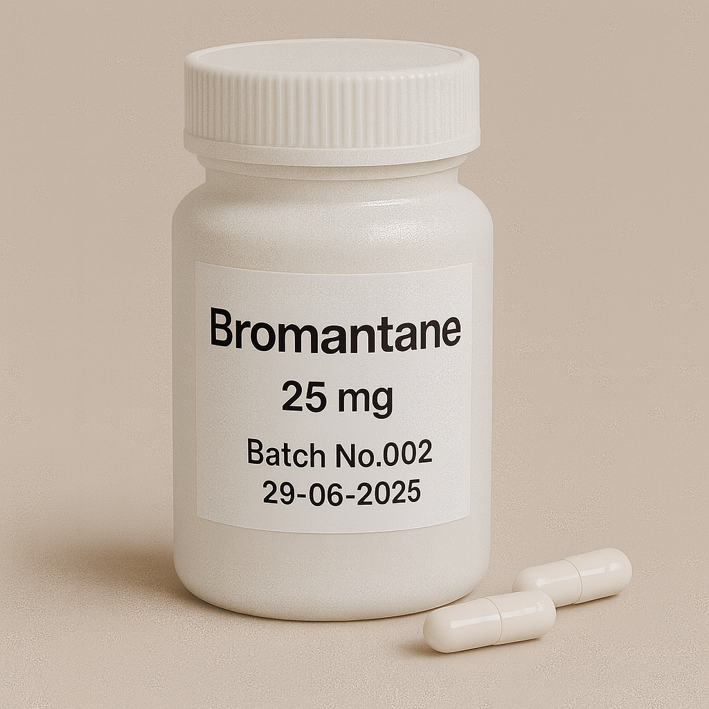 White plastic pill bottle labeled "Bromantane, 25 mg, Batch No.002, 29-06-2025" on a beige background, with two white capsules lying beside it.