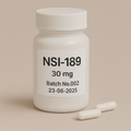 White plastic pill bottle labeled "NSI-189, 30 mg, Batch No.002, 23-06-2025" on a beige background, with two white capsules lying beside it
