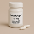 A photograph of a white plastic pill bottle labeled "Noopept, 10 mg, Batch No.002, 16-05-2025." The bottle stands on a beige surface with two white capsules placed neatly in front. Minimalist beige background and sharp black typography emphasize the clean, professional pharmaceutical design