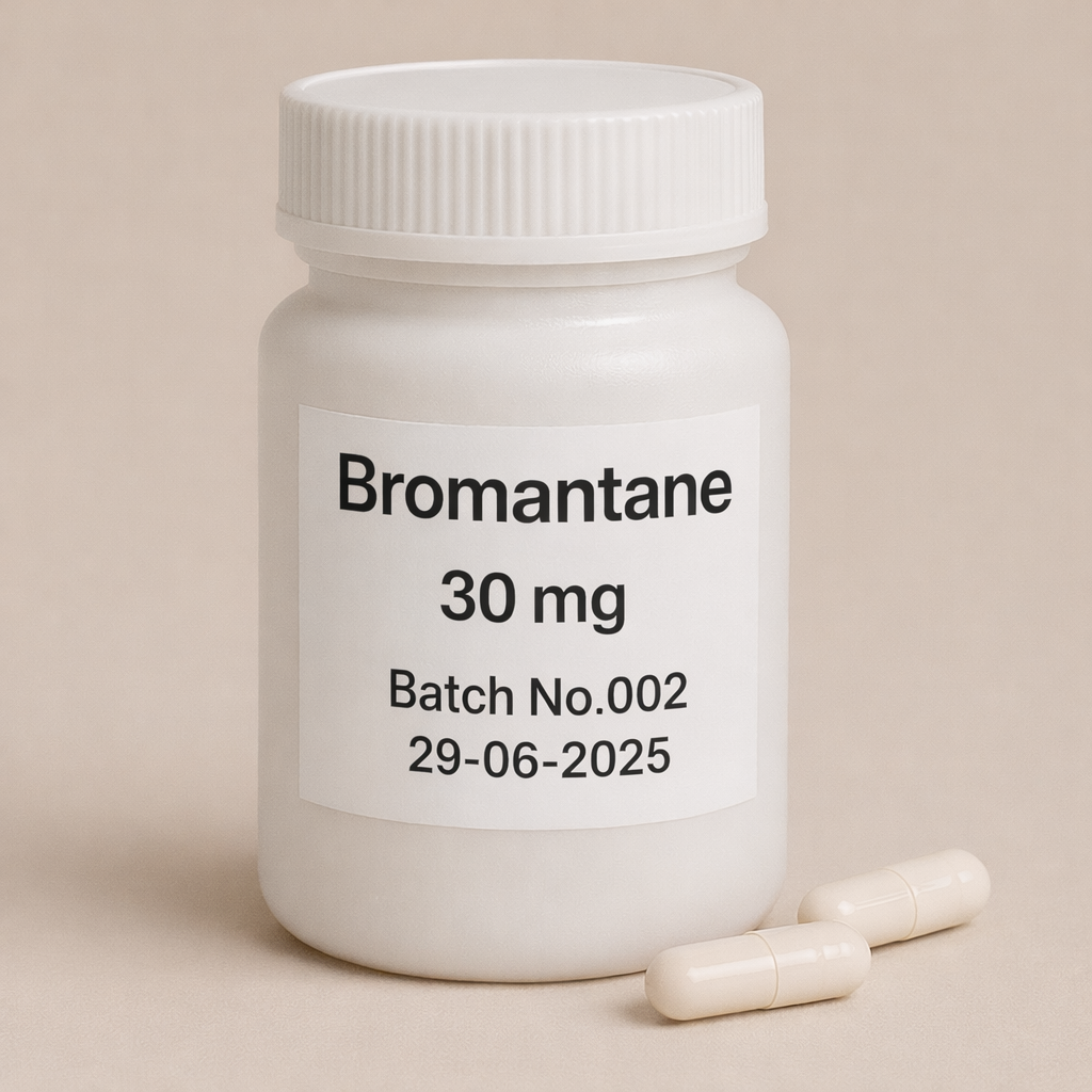A high-resolution digital photograph of a white cylindrical plastic pill bottle labeled "Bromantane 30 mg, Batch No.002, 29-06-2025." The bottle is standing upright on a soft beige background, accompanied by two off-white capsules placed in the foreground. The label is clearly legible, and the lighting is even and natural, highlighting the clean, clinical appearance of the product