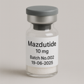 Glass vial labeled 'Mazdutide 10 mg, Batch No.002, 19-06-2025' containing a white lyophilized powder, sealed with a gray rubber stopper and matte silver cap, displayed against a soft beige background