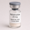 Retatrutide 20 mg vial with white lyophilized powder, labeled Batch No. 008 and expiration date 11-03-2026, shown in a clear glass vial with a gray cap on a soft neutral background.