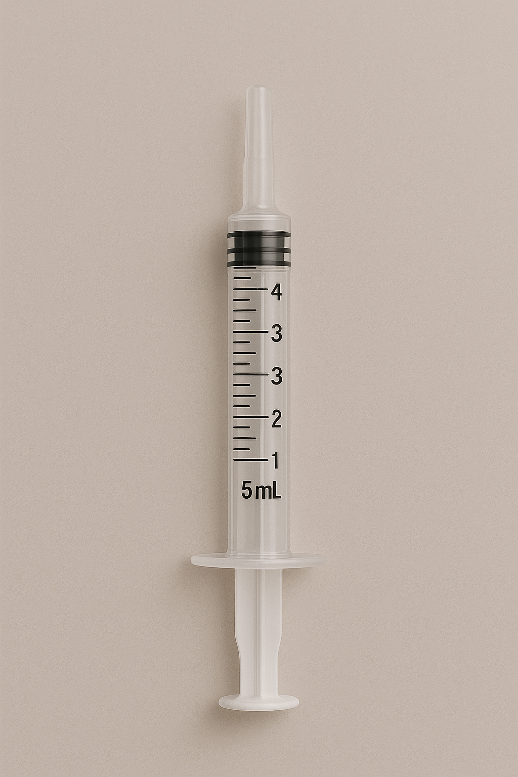 Medical syringe with measurement markings on a beige background